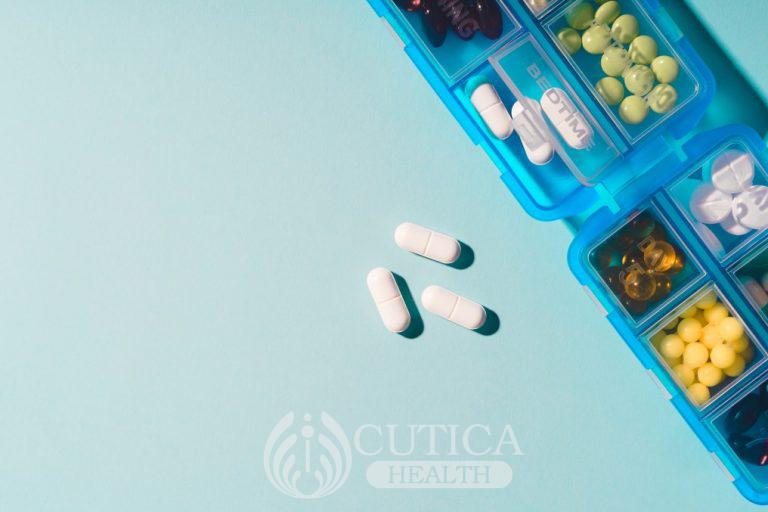 prescription-pills-and-vitamins-in-a-blue-pill-box-on-neo-mint-color-background-flat-lay-photo-space_t20_Xv8nEG-768x512